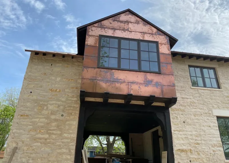 Copper metal panel facade on a stone building for Skylight Installation in Beeville