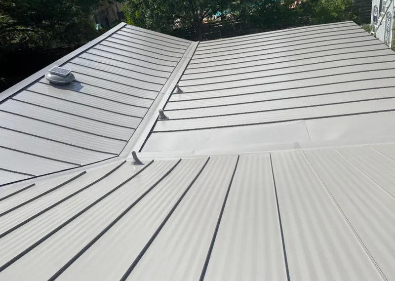 Solar attic fan installed on a metal roof for Roof Ventilation in Beeville